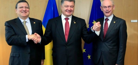 Ukraine's President Petro Poroshenko, center, poses with European Commission President Jose Manuel Barroso, left, and European Council President Herman Van Rompuy, right, during an EU Summit in Brussels on Friday, June 27, 2014. Ukrainian President Petro Poroshenko has signed up to a trade and economic pact with the European Union, saying it may be the 